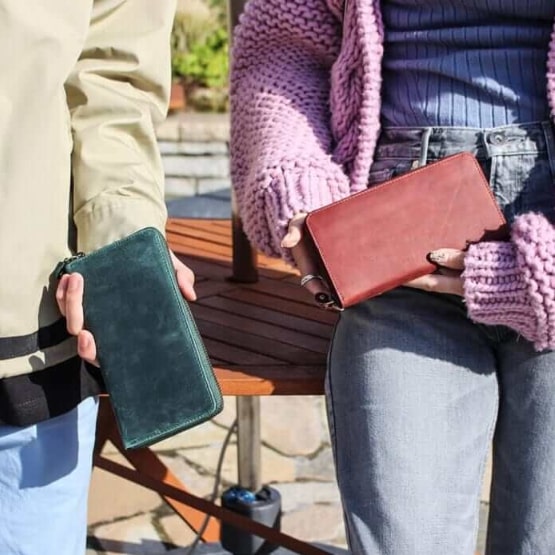 ハレルヤのダークグリーンの長財布を持つ男性とワインレッドの長財布を持つ女性